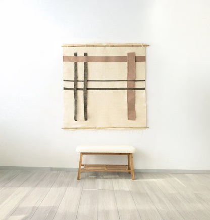 Minimalist beige wall tapestry with geometric lines and rectangular patterns, suspended on a bamboo rod, perfect as a modern or Japandi-style wall decor piece.