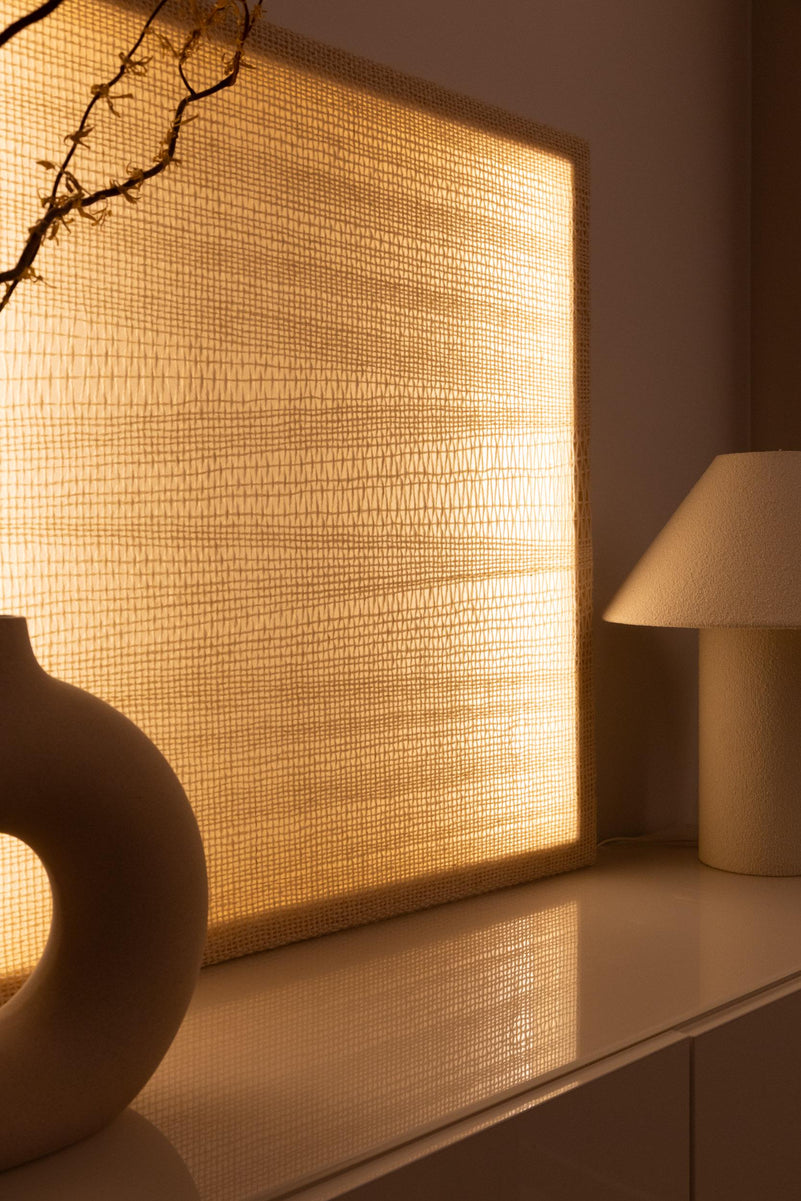 Angled view of Ma showing the layered wool weave, wooden frame and warm integrated lighting