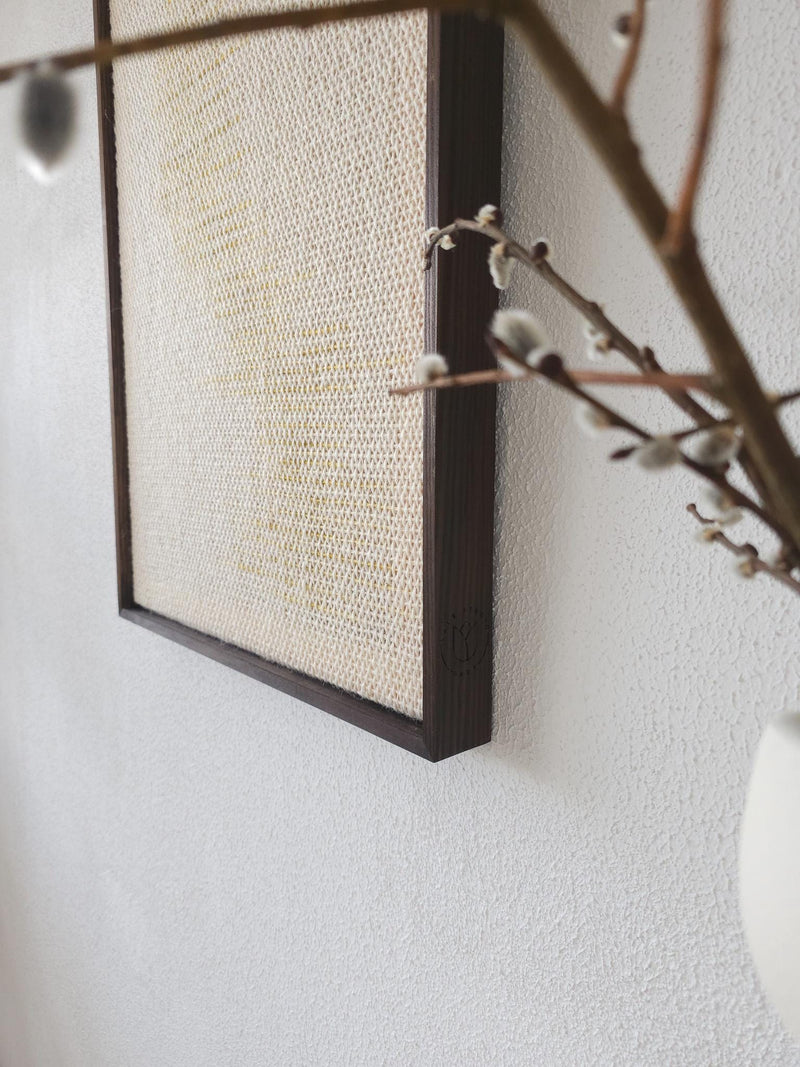 Millip framed tapestry on a neutral wall, minimalist interior