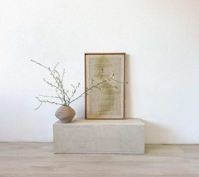 Close view of Millip's handwoven texture inside the wood frame