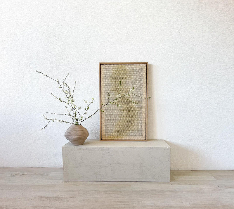 Close view of Millip's handwoven texture inside the wood frame