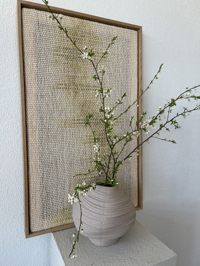 Millip framed wall art shown at an angle to reveal the slim frame