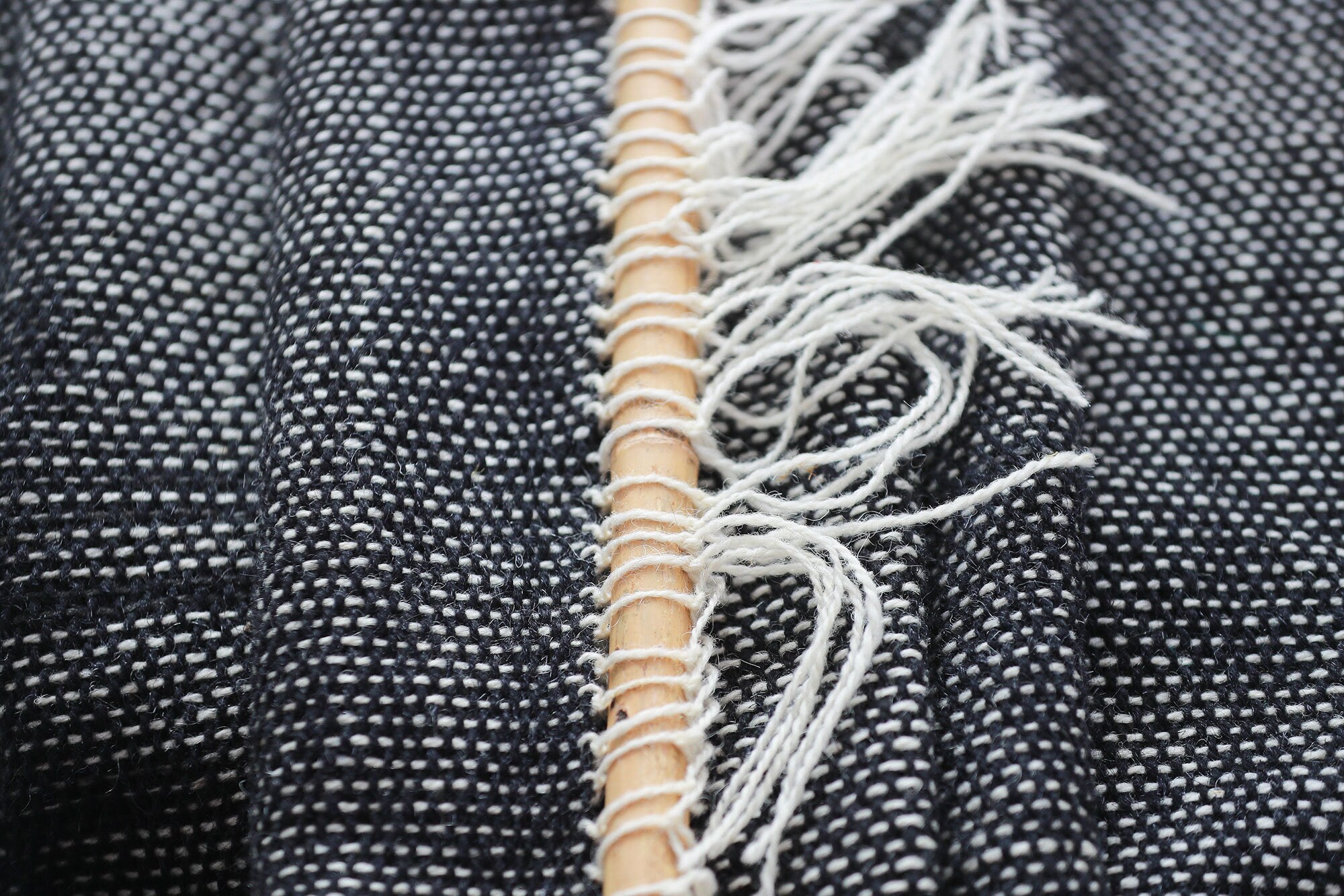 Misty Ink dark woven wall hanging styled in a minimalist Scandinavian living room