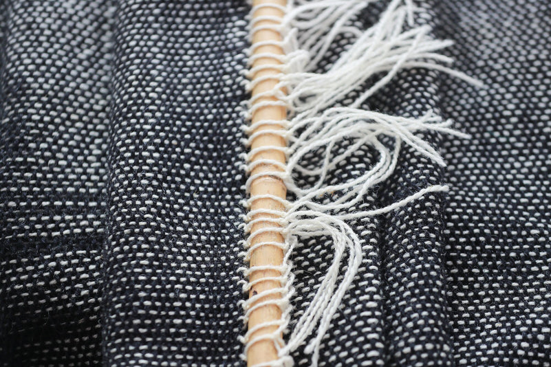 Misty Ink dark woven wall hanging styled in a minimalist Scandinavian living room