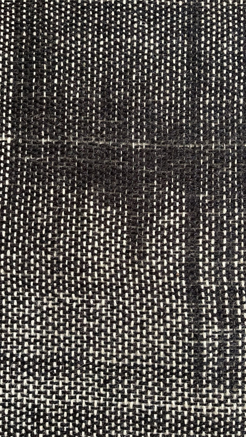 Close view of Misty Ink's dense black handwoven surface