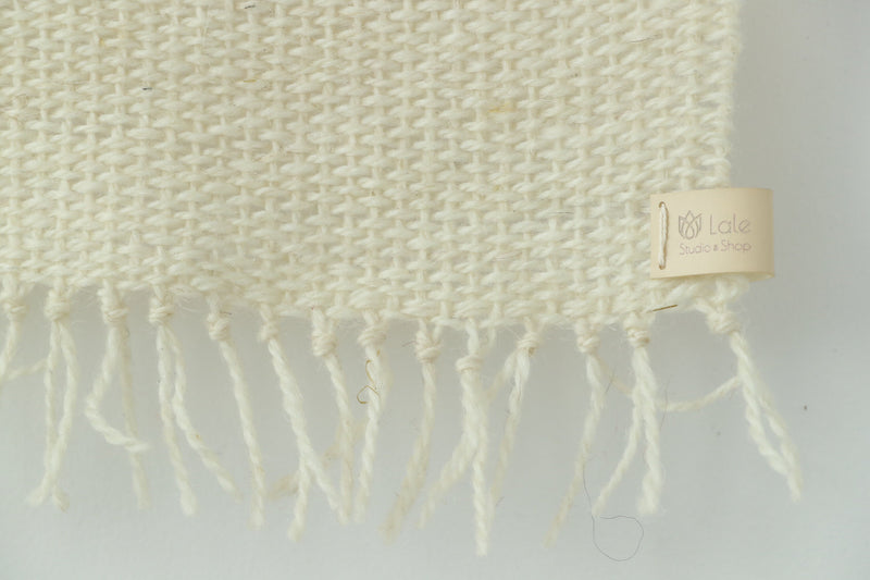 Misty Pearl tapestry on a white plaster wall, minimalist Scandinavian interior