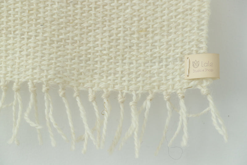 Misty Pearl tapestry on a white plaster wall, minimalist Scandinavian interior