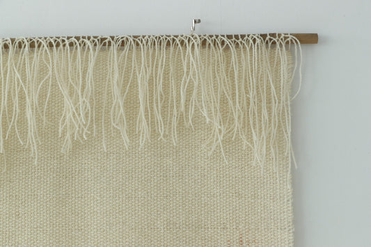 Misty Pearl styled above a wooden sideboard in a calm bedroom