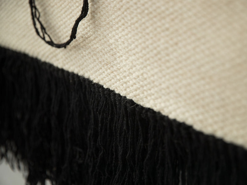 Naia tapestry on a neutral wall, minimalist interior