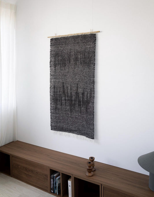 Nyora handwoven charcoal wool wall hanging, full view of the dripping vertical pattern on a bamboo rod — Lale Studio & Shop
