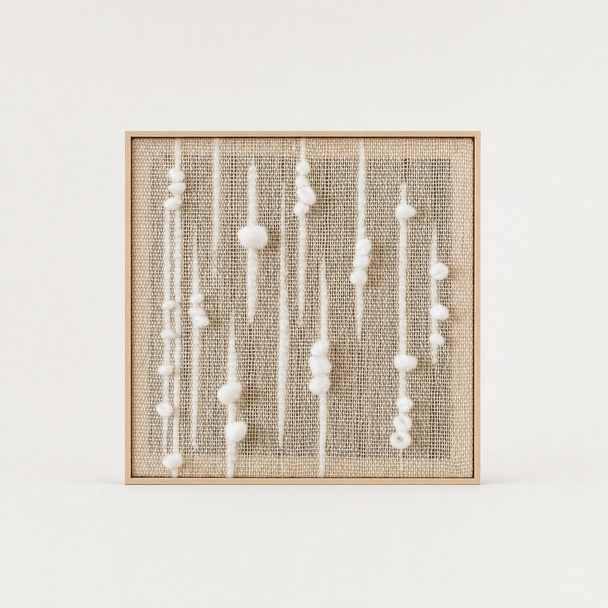 Olit square handwoven two-ply wool tapestry with vertical beaded strands of white wool nubs on a natural beige weave in a slim light wood frame, framed textile wall art by Lale Studio & Shop