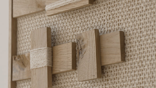 Quiet Form handwoven wool and oak tapestry shown hanging on a wall