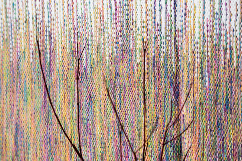 Detail of Rainbow's multicolour yarn and white fringe