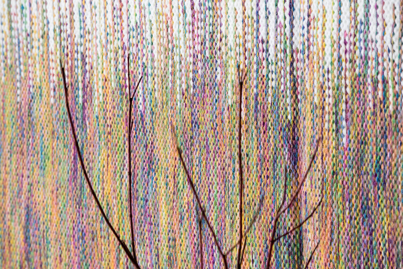 Detail of Rainbow's multicolour yarn and white fringe