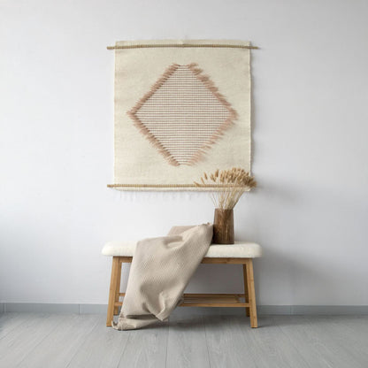 Rombo S handwoven tapestry with a diamond pattern in natural wool and beige tones, featuring light brown accents. A smaller yet elegant centerpiece perfect for minimalist and boho interiors.