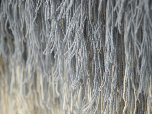 Snow handwoven wool tapestry shown hanging on a wall