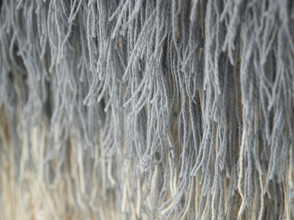 Snow handwoven wool tapestry shown hanging on a wall