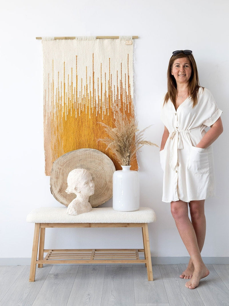 Detail of Sune's two-ply wool weave and vertical fringe in golden sunset colours