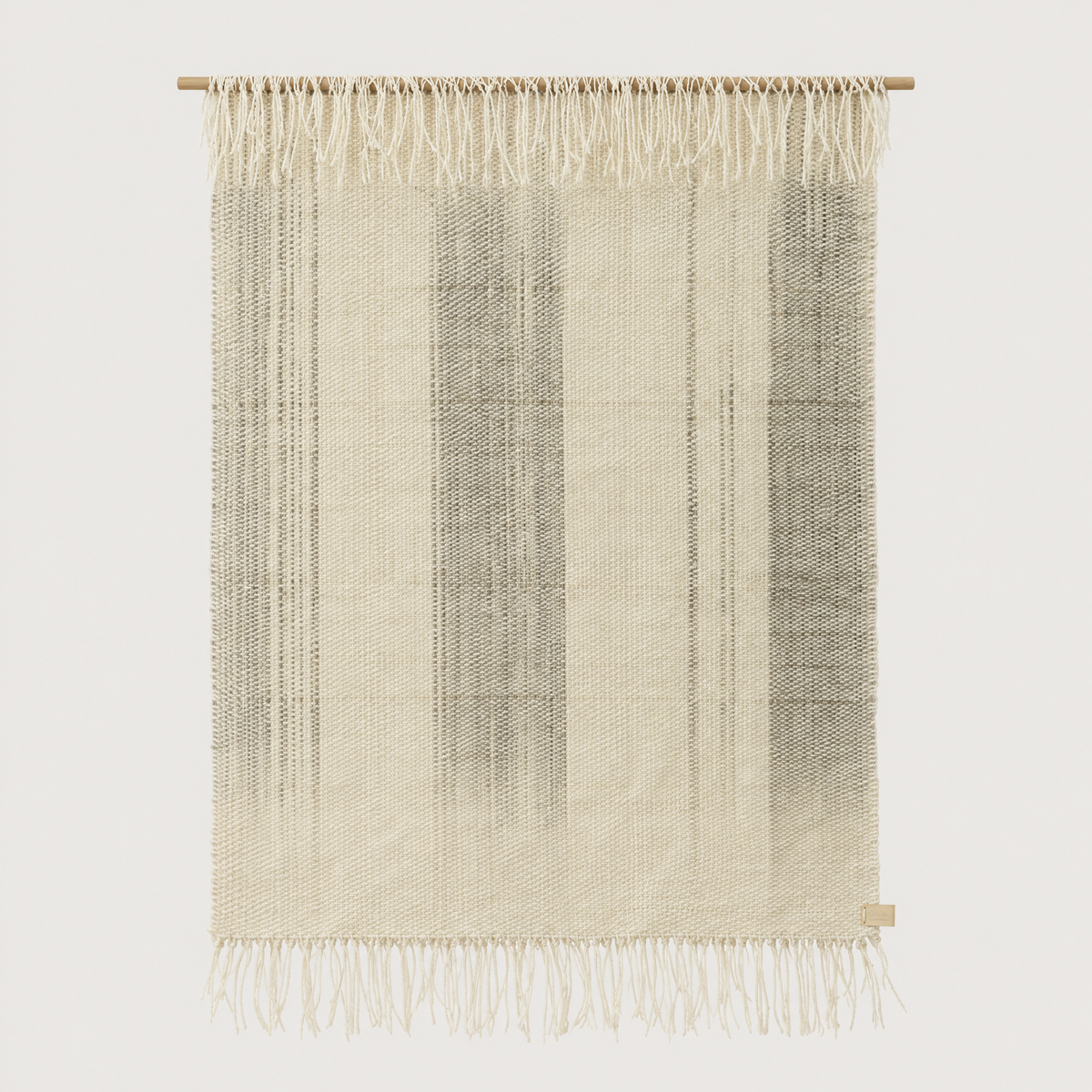 Surge handwoven wool wall hanging in natural beige with grey dip dye gradient and bottom fringe on a bamboo rod, Lale Studio & Shop