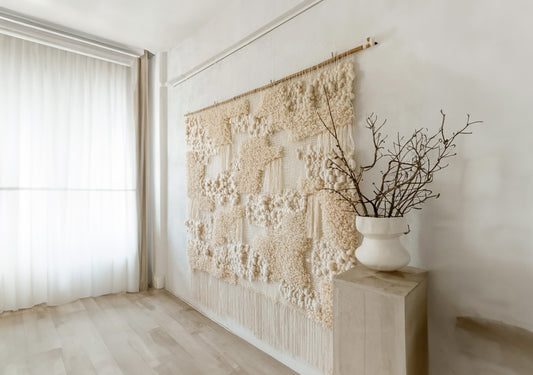 Totipoa handwoven wall tapestry crafted from natural wool and cotton in neutral beige tones, featuring tufted textures and a large size, styled in a modern interior by Lale Studio.