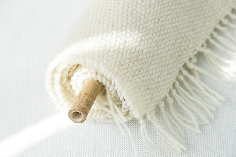 Corner detail of Veil's natural wool fringe