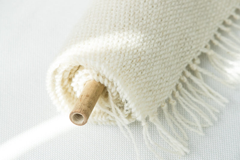 Corner detail of Veil's natural wool fringe