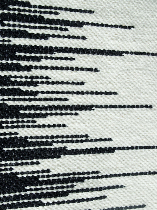 Zebra handwoven wool tapestry shown hanging on a wall