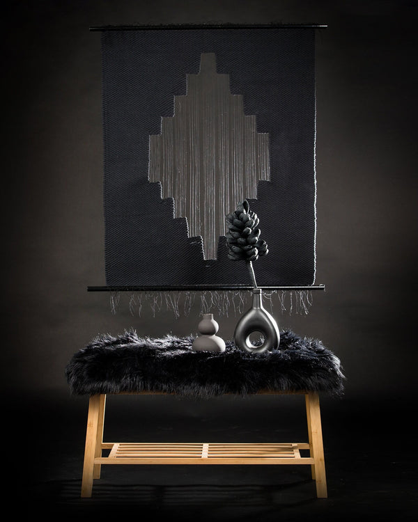 Lohe handwoven cotton tapestry shown hanging on a wall